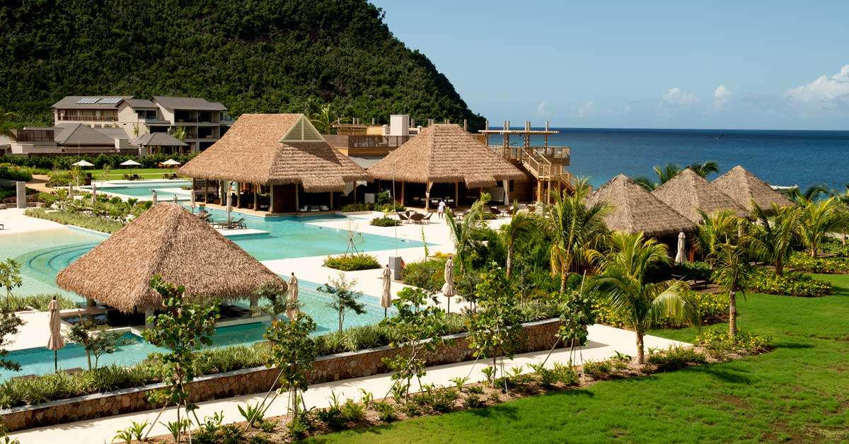 Cape Reed synthetic thatch chalets with timber decking and balustrades