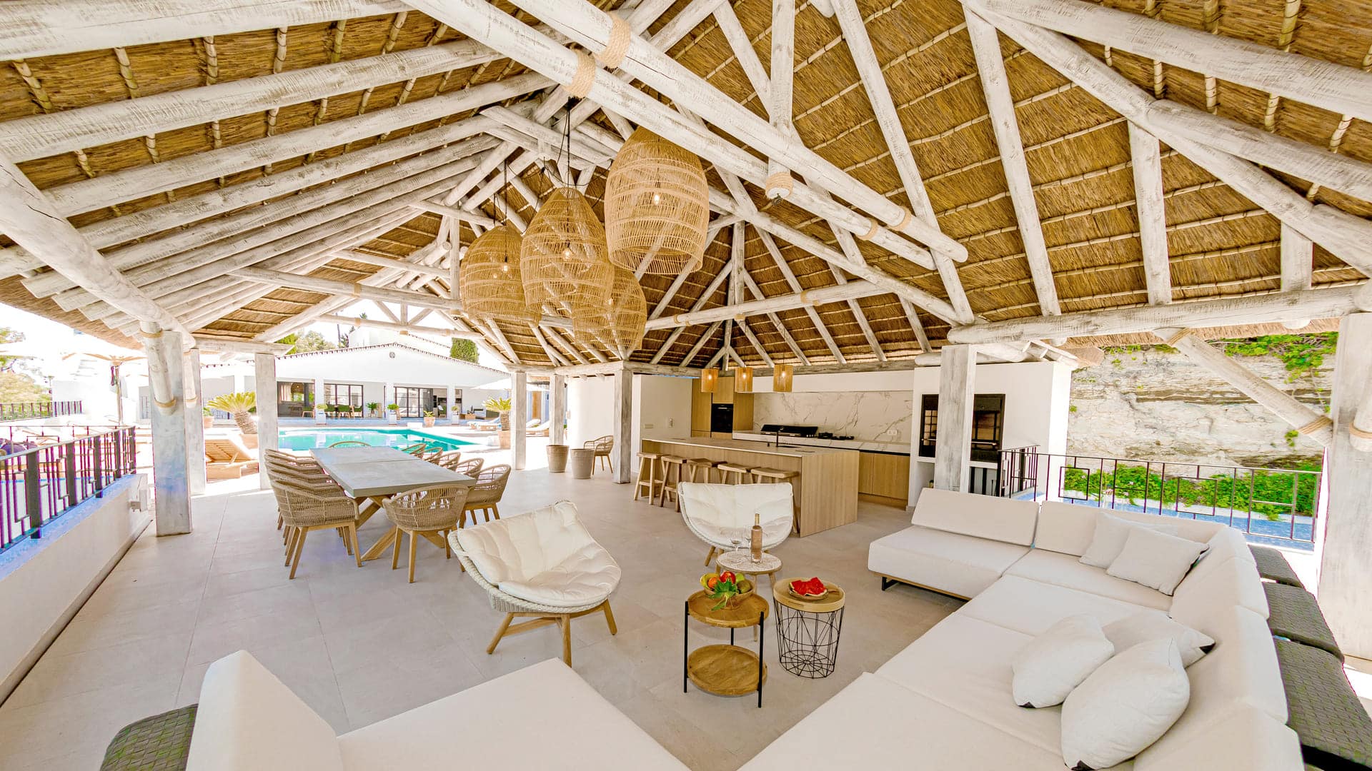Tucked beneath the natural shade of a Cape Reed thatched roof, this fully equipped outdoor kitchen is the ultimate entertaining hub.