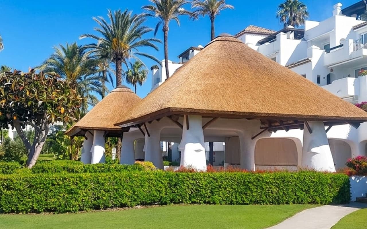 Refurbished thatched roof gazebo at Alcazaba Beach Estepona with Cape Reed thatch and tropical gardens